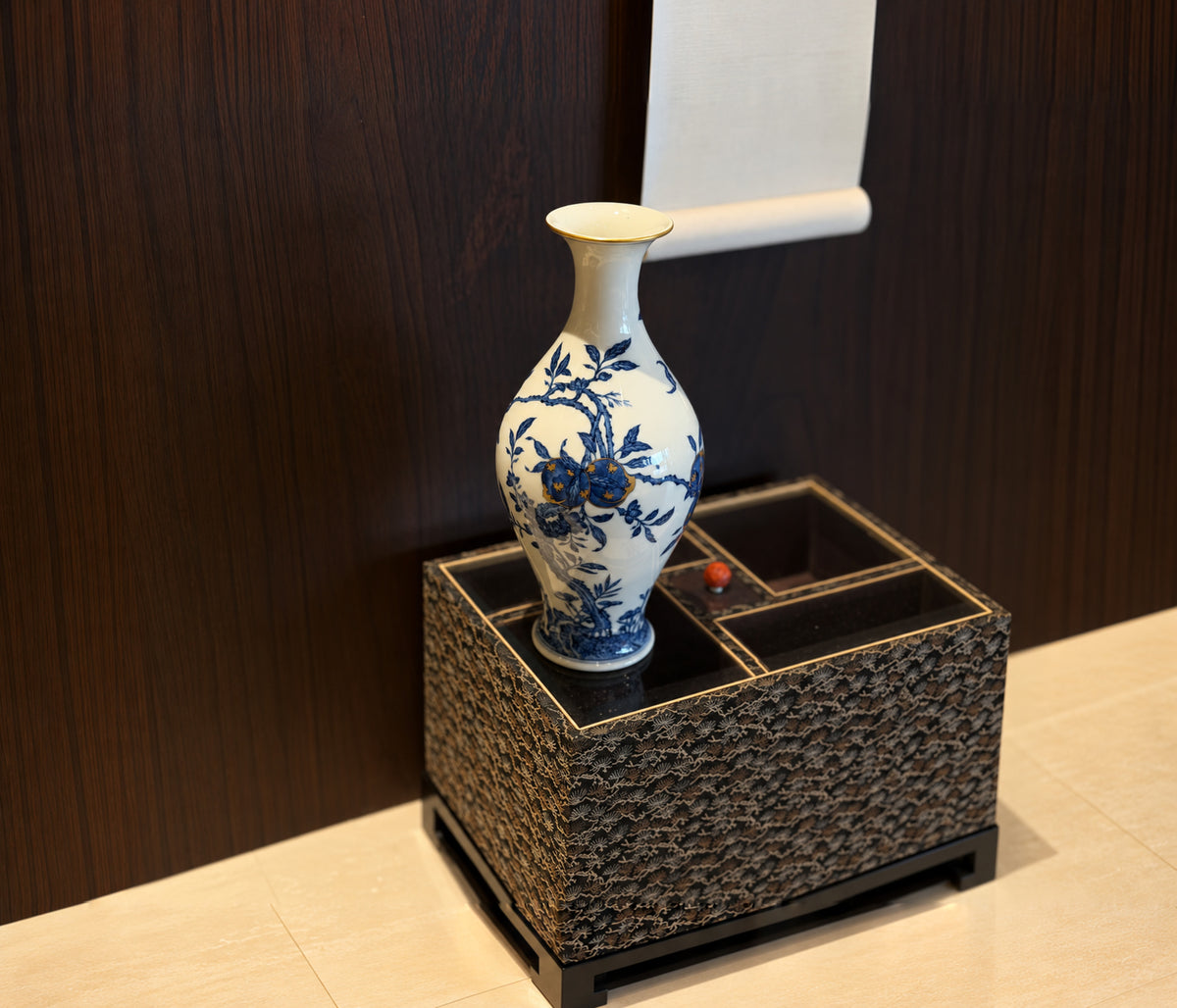 Blue-and-white porcelain vase on a woven pedestal