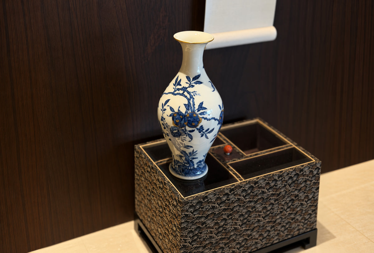 Blue-and-white porcelain vase on a woven pedestal