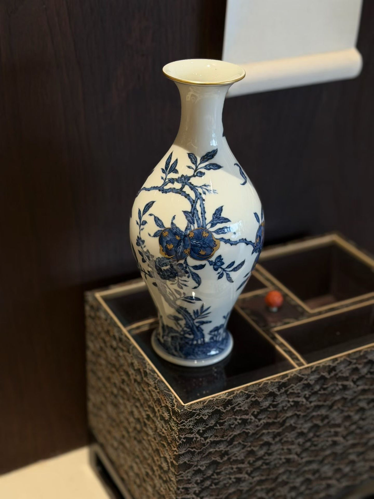 Blue-and-white porcelain vase on a woven pedestal